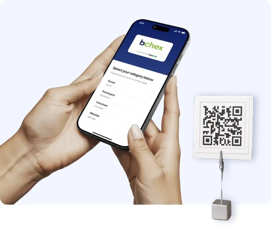 Visitor checking in with ChexPass by scanning a QR code on a phone