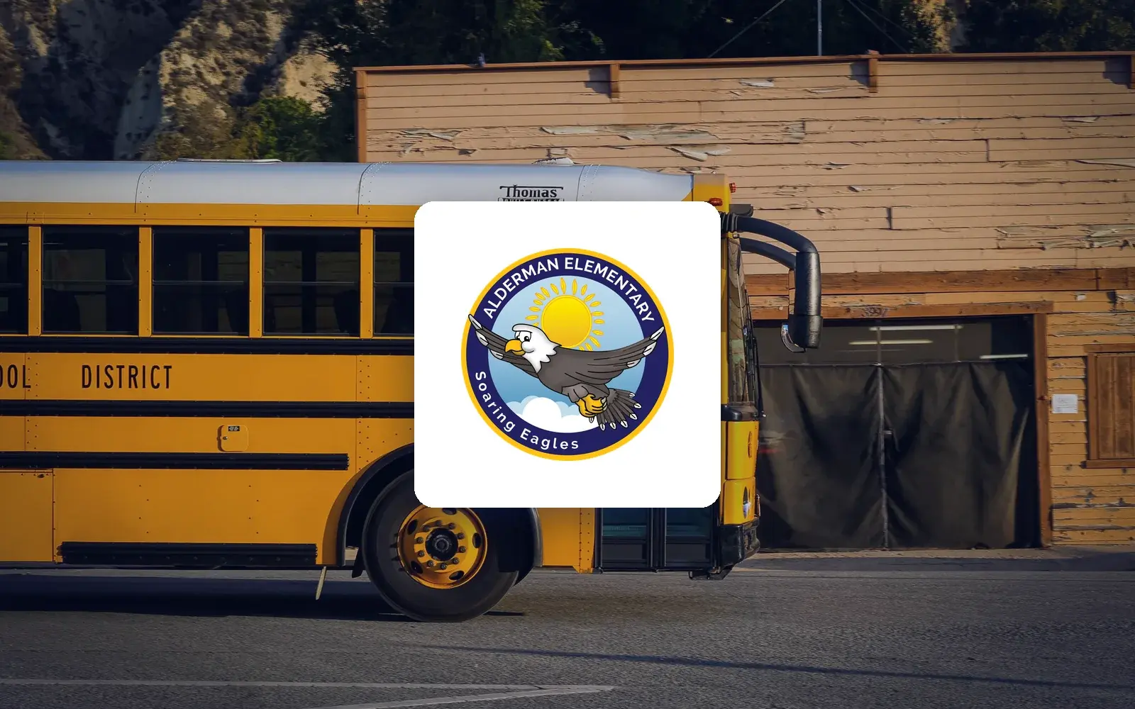 Alderman Elementary School logo over a yellow school bus