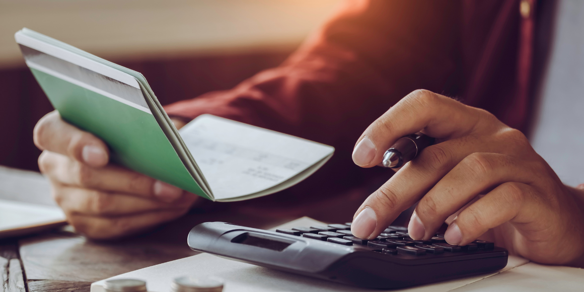 Man doing math on a calculator